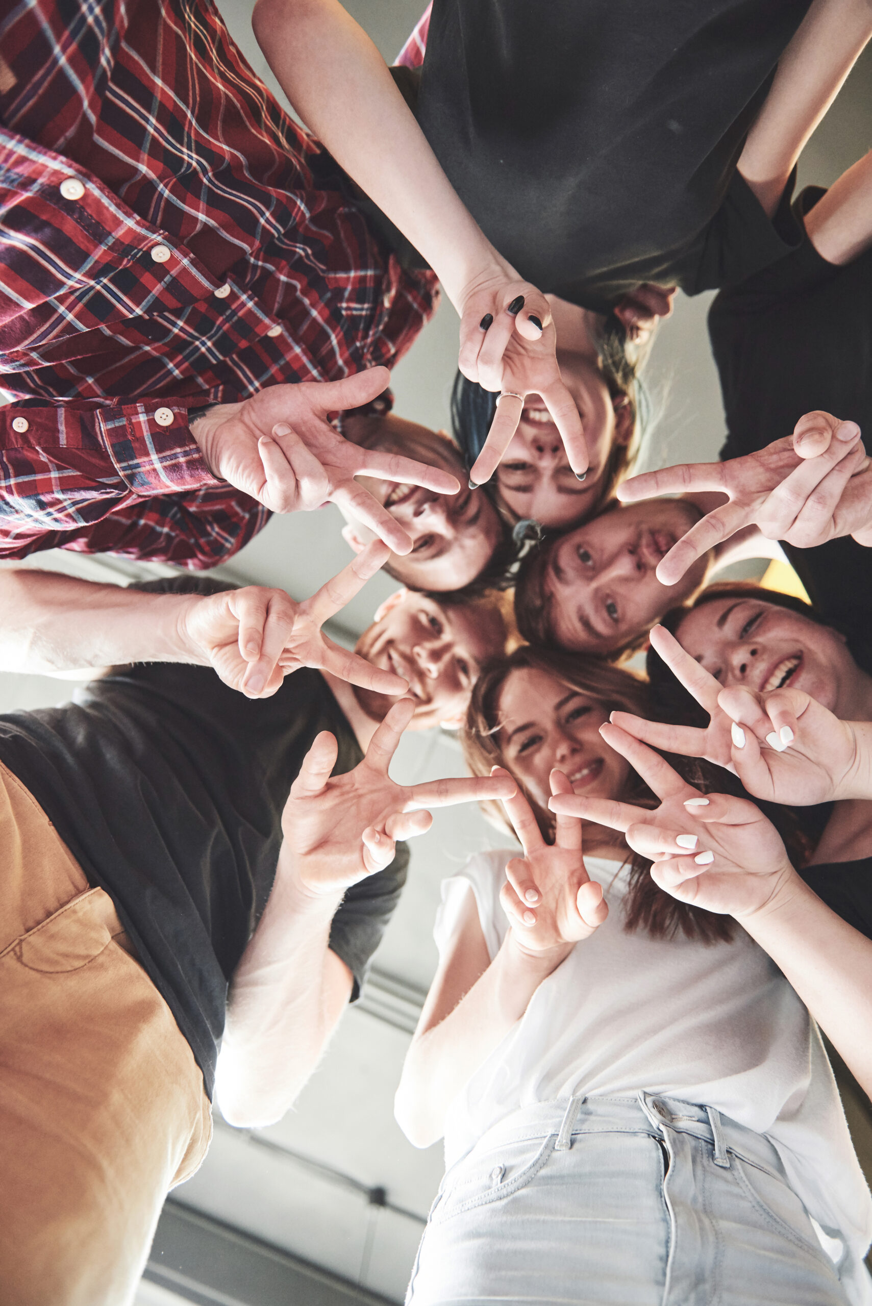 happy group friends with their hands together middle scaled